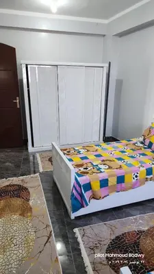 a bedroom with a bed with a colorful comforter at sky spirit in Luxor