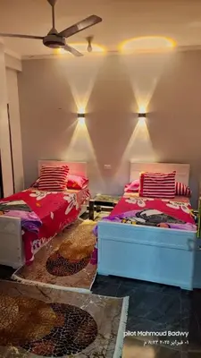 a bedroom with two beds and a ceiling at sky spirit in Luxor