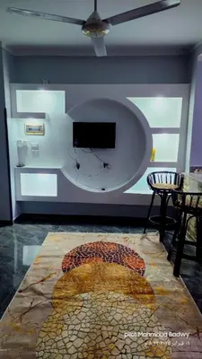 a room with a table and a tv on a wall at sky spirit in Luxor