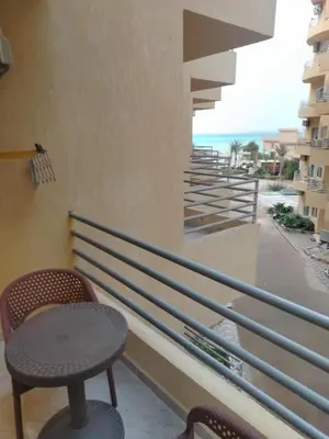 a balcony with a table and chairs and the ocean at Hurghada Fiesta Resort Studio 328 in Hurghada