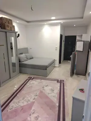 a living room with a bed and a rug at Hurghada Fiesta Resort Studio 328 in Hurghada
