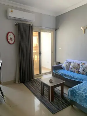 a living room with a blue couch and a table at Apartment in centre of Hurghada in Hurghada