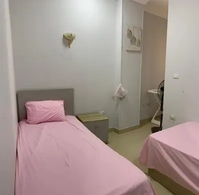 a room with two beds with pink sheets at Apartment in centre of Hurghada in Hurghada