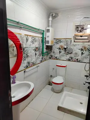 a bathroom with a toilet and a sink at اسوان ـ خلف مول بلازا ـ بجوار فرست مول in Aswān
