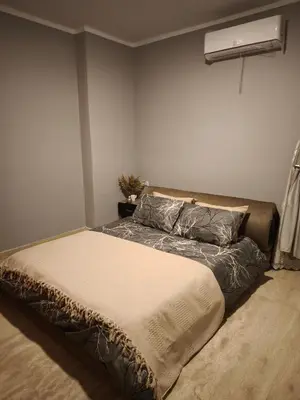 a bed in a bedroom with a air conditioner at Soho compound in Hurghada