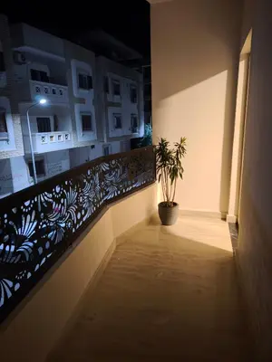 a hallway with a potted plant on a balcony at Soho compound in Hurghada