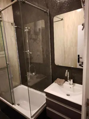 a bathroom with a shower and a sink and a mirror at Soho compound in Hurghada