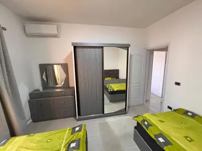a bedroom with a mirror and a bed and a dresser at Apartment with a Red Sea view in Hurghada