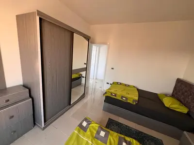 a bedroom with a mirror and a bed with yellow sheets at Apartment with a Red Sea view in Hurghada