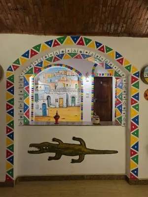 a wall with a dinosaur painted on it at Zena Toma Nubian Guest House in Aswan