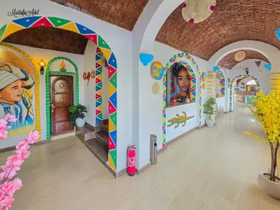 a room with paintings on the walls of a building at Zena Toma Nubian Guest House in Aswan