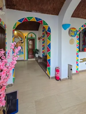a room with a colorful door in a house at Zena Toma Nubian Guest House in Aswan