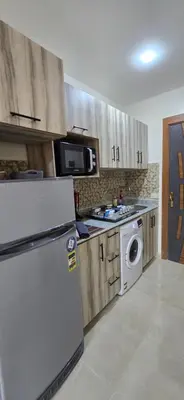 a kitchen with a refrigerator and a microwave at Tiba Golden Marina Bay Hurghada in Hurghada