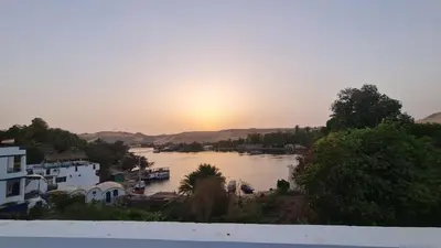 a view of a river with the sunset in the background at Toto Kato in Jazīrat Aswān