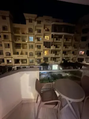 a table and chairs on the balcony of a building at Florenza Khamsin Resort in Hurghada