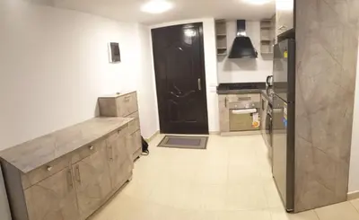 a kitchen with a black door and a white floor at Florenza Khamsin Resort in Hurghada