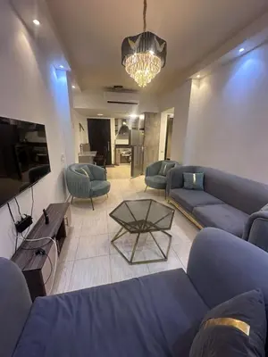 a living room with blue couches and a table at Florenza Khamsin Resort in Hurghada
