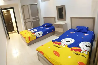 a bedroom with two beds with hello kitty sheets at Florenza Khamsin Resort in Hurghada