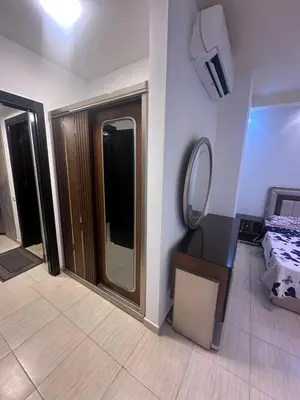 a bedroom with a vanity and a mirror and a bed at Florenza Khamsin Resort in Hurghada