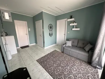 a living room with a gray couch and green walls at Nile Spirit Sunrise in Luxor