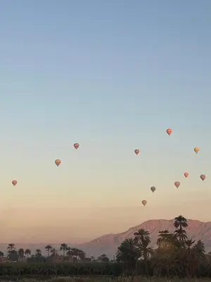a group of hot air balloons flying in the sky at Nile Spirit Sunrise in Luxor