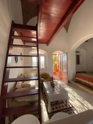 a room with bunk beds and a living room at Apartment at Upper Nubia lagoon El Gouna in Hurghada