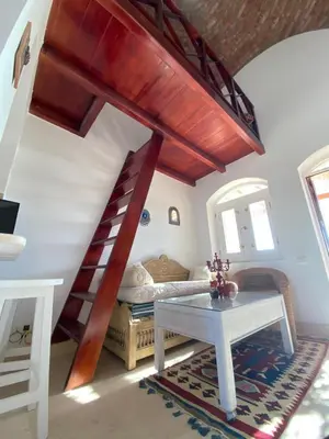 a room with a staircase with a table and a bed at Apartment at Upper Nubia lagoon El Gouna in Hurghada