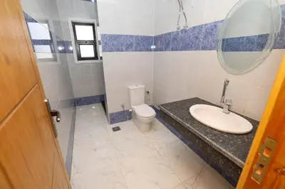 a bathroom with a sink and a toilet and a mirror at Serenity House Luxor in Luxor
