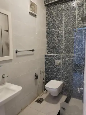 a bathroom with a toilet and a sink at Al Khaother in Hurghada
