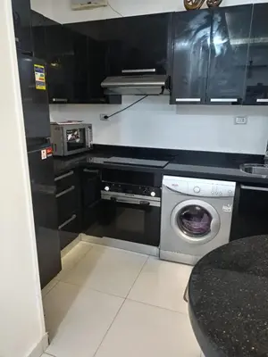 a kitchen with a washer and a washing machine at Al Khaother in Hurghada