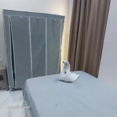 a white toy bird sitting on top of a bed at Modern studio in Hurghada
