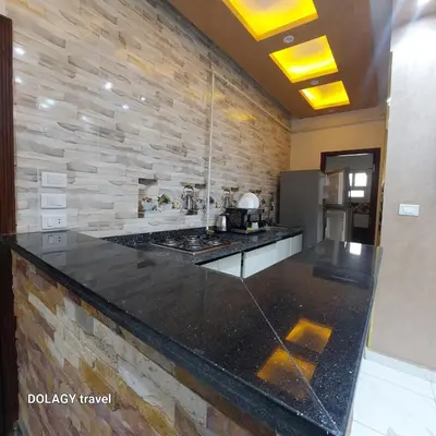 a kitchen with a counter top and a stone wall at Modern studio in Hurghada