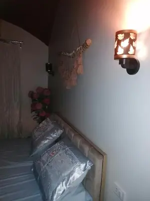 a bedroom with a bed with two pillows and a lamp at 265 Apartment in Hurghada