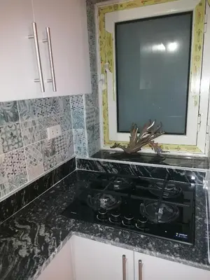 a kitchen with a stove and a tv on the counter at 265 Apartment in Hurghada