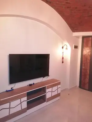 a living room with a flat screen tv on a wall at 265 Apartment in Hurghada