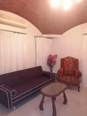 a living room with a couch and a chair at 265 Apartment in Hurghada
