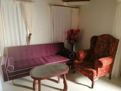 a living room with a purple couch and a chair at 265 Apartment in Hurghada