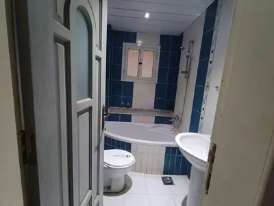 a bathroom with a toilet and a tub and a sink at Ahmeds in Luxor