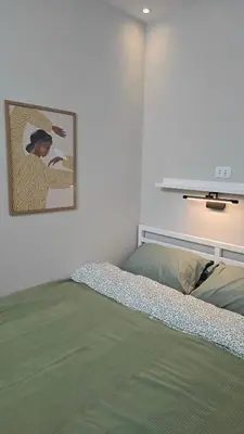 a bedroom with a bed and a picture on the wall at Florenza Khamsin Lux Apartment in Hurghada