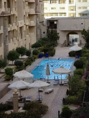 an overhead view of a pool with umbrellas at Florenza Khamsin Lux Apartment in Hurghada
