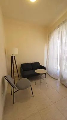 a living room with a couch and a table at Florenza Khamsin Lux Apartment in Hurghada