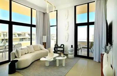 a living room with a white couch and large windows at Cozy getaway in El Gouna with pool & mountain view in Hurghada