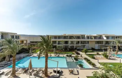an aerial view of a resort with a pool and palm trees at Cozy getaway in El Gouna with pool & mountain view in Hurghada