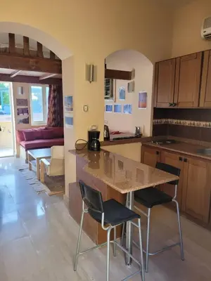 a kitchen and living room with a table and chairs at Charming Studio in Downtown El Gouna in Hurghada