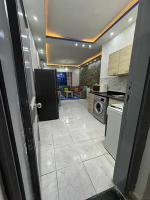 a kitchen with a door open to a living room at Modern European Style apartment 1 in Hurghada
