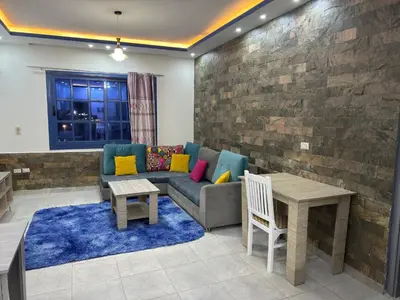 a living room with a couch and a table at Modern European Style apartment 1 in Hurghada