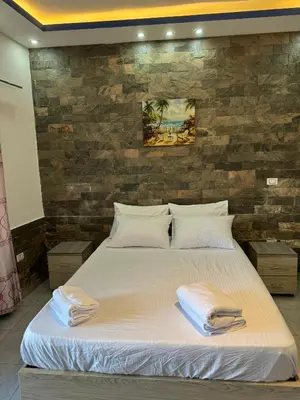 a bedroom with a large bed with towels on it at Modern European Style apartment 1 in Hurghada