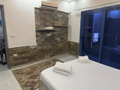 a room with a bed with two towels on it at Modern European Style apartment 1 in Hurghada