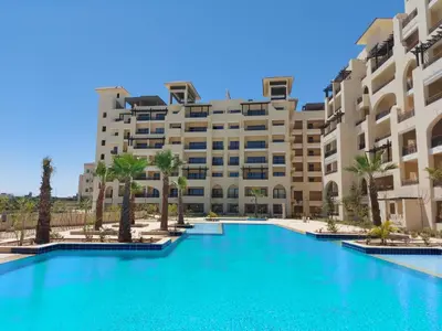 a large swimming pool in front of a building at Amazing Apartment Aldau Heights in Hurghada