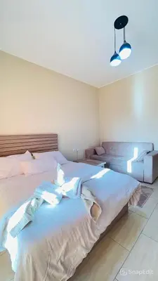a bedroom with a large white bed with two pillows at Amazing Apartment Aldau Heights in Hurghada